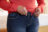 Close,Up,Of,Overweight,Woman,Trying,To,Fasten,Trousers
